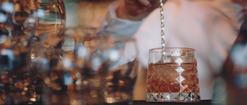 A bartender stirs a cocktail